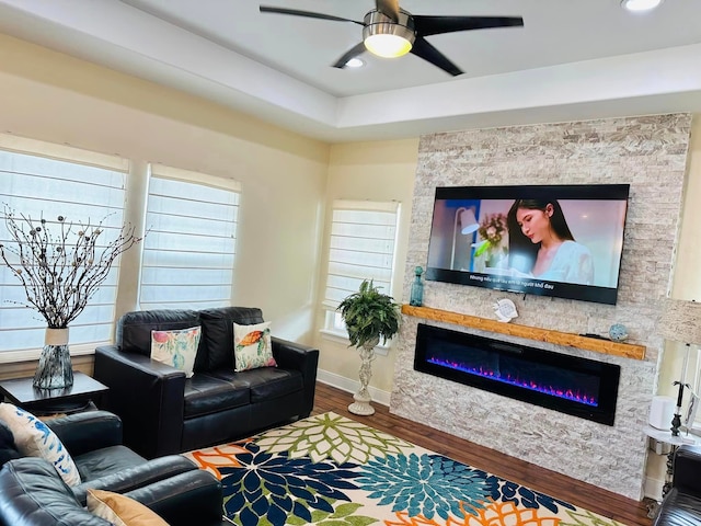 living room with a fireplace, hardwood / wood-style flooring, and ceiling fan