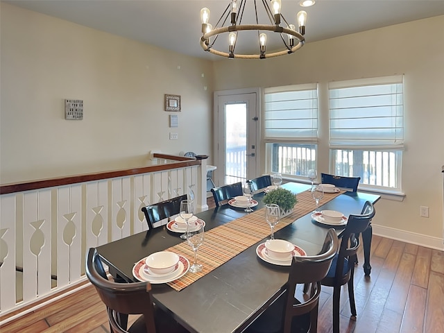 dining area with a notable chandelier and hardwood / wood-style flooring