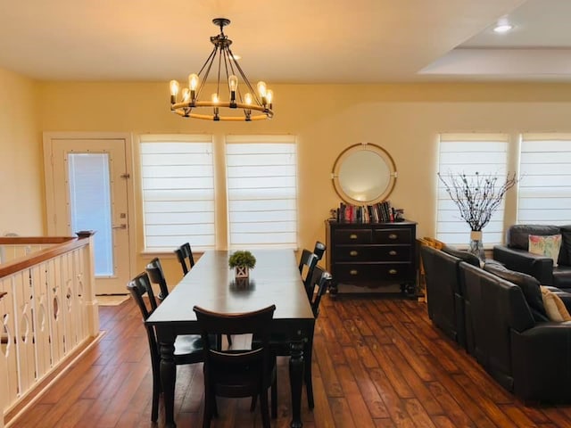 dining space featuring an inviting chandelier and dark wood-type flooring