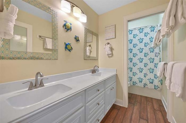 bathroom featuring hardwood / wood-style flooring, vanity, and shower / tub combo with curtain