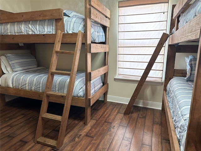 bedroom with dark hardwood / wood-style flooring