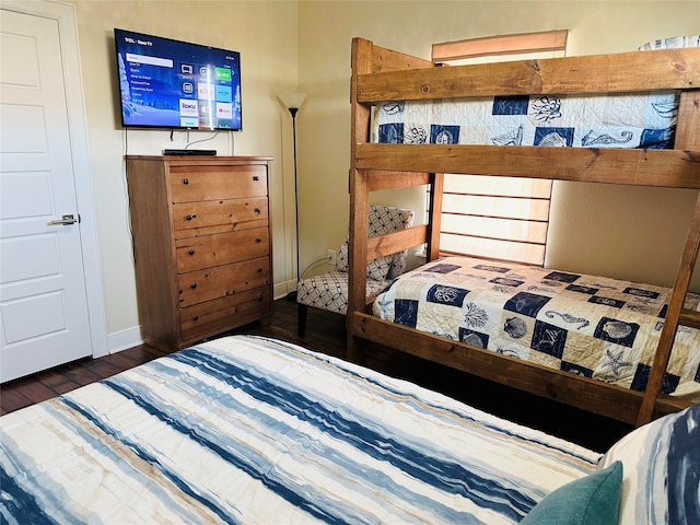 bedroom with dark hardwood / wood-style floors