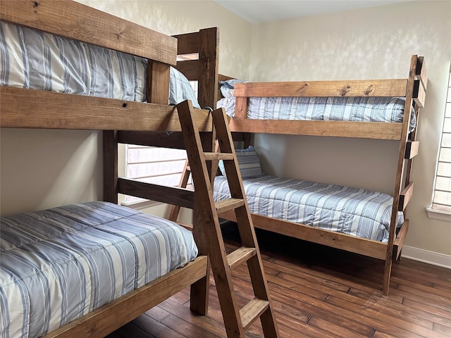 bedroom with dark hardwood / wood-style flooring