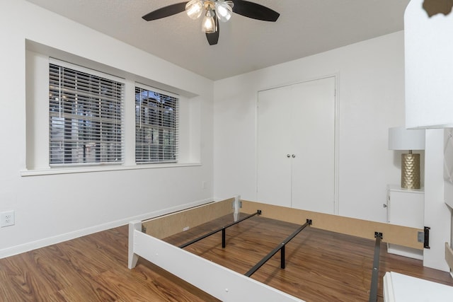 interior space with a closet, hardwood / wood-style flooring, and ceiling fan