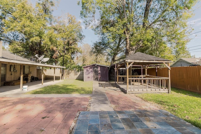 exterior space featuring a gazebo, a storage shed, a patio, and a lawn