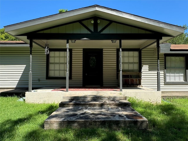 view of exterior entry featuring a porch