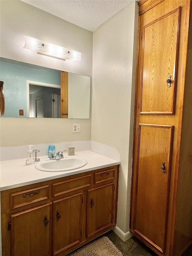 bathroom featuring vanity and a textured ceiling