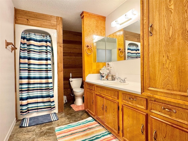 bathroom with curtained shower, vanity, a textured ceiling, and toilet