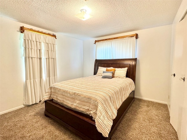 carpeted bedroom with a textured ceiling