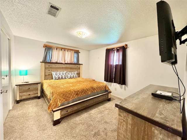 carpeted bedroom with a textured ceiling