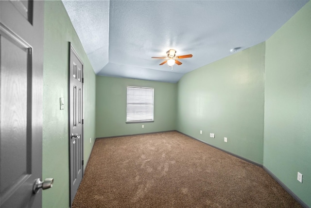 unfurnished bedroom featuring carpet flooring, ceiling fan, a textured ceiling, and vaulted ceiling