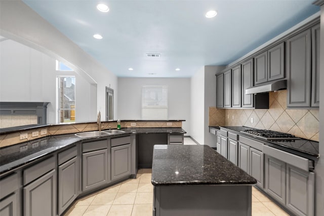 kitchen featuring a kitchen island, a wealth of natural light, and gray cabinetry