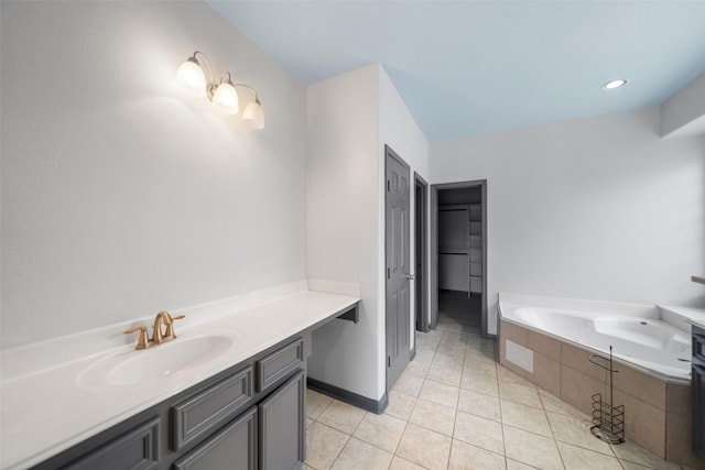 bathroom with vanity, tile patterned floors, and tiled tub