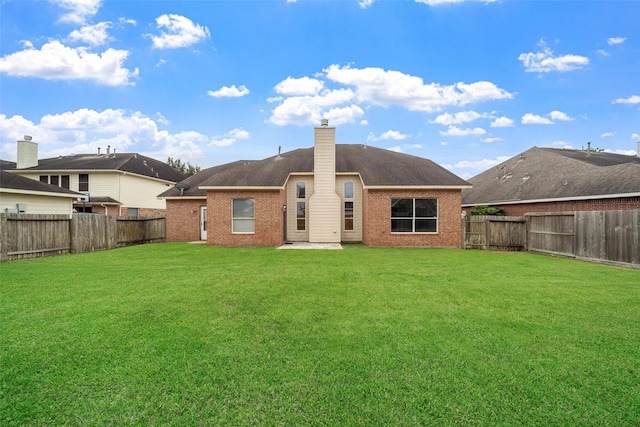 rear view of property featuring a yard