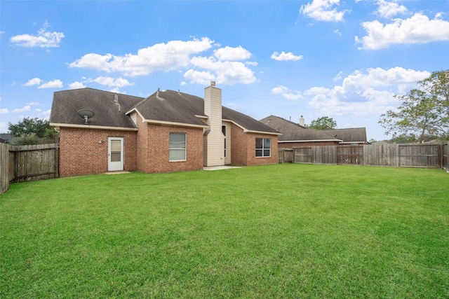 back of house featuring a lawn