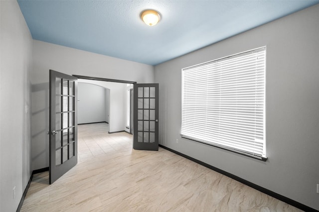 spare room featuring french doors