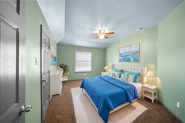 carpeted bedroom featuring ceiling fan and vaulted ceiling