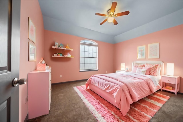 carpeted bedroom with ceiling fan and vaulted ceiling