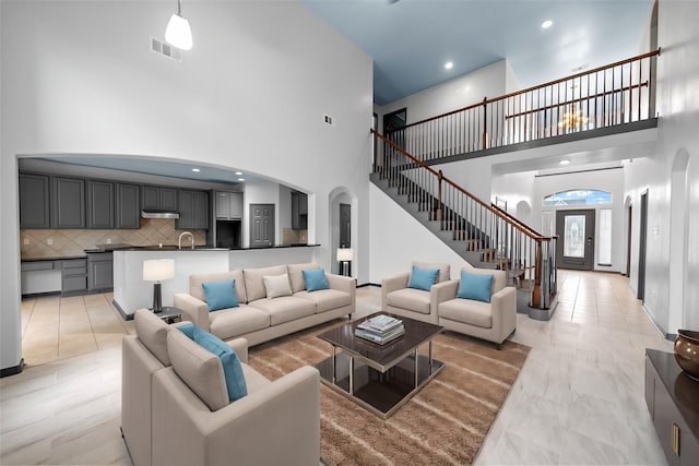 living room featuring sink and a high ceiling