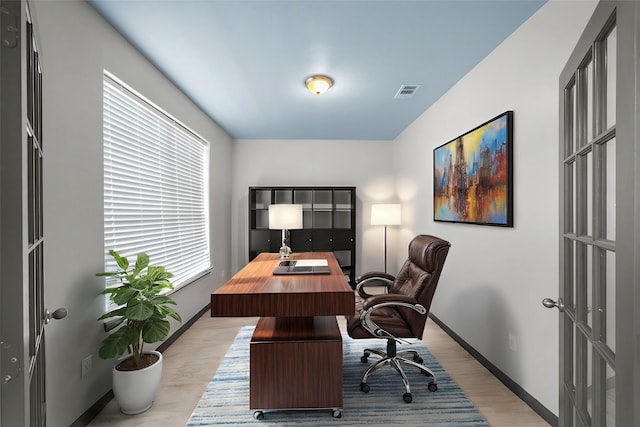 office space featuring light hardwood / wood-style flooring and french doors