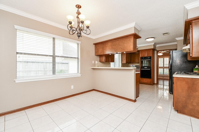 kitchen featuring decorative light fixtures, plenty of natural light, black double oven, and kitchen peninsula