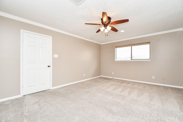 unfurnished room with ornamental molding, light colored carpet, ceiling fan, and a textured ceiling