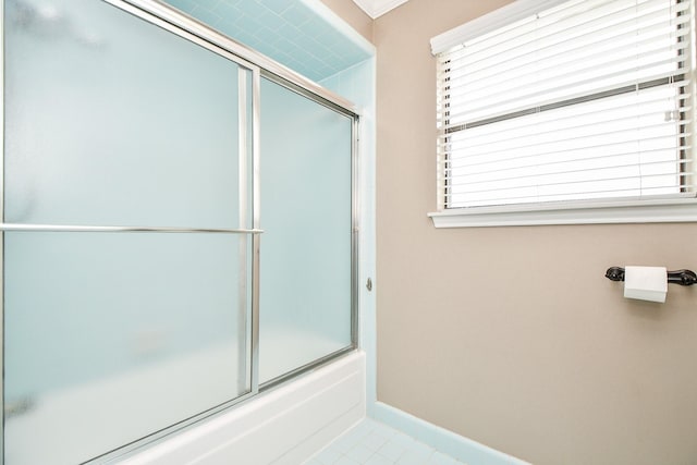 bathroom with enclosed tub / shower combo and tile patterned floors