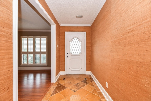 entrance foyer featuring crown molding and a textured ceiling