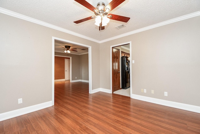 spare room featuring crown molding, ceiling fan, a textured ceiling, and light wood-type flooring