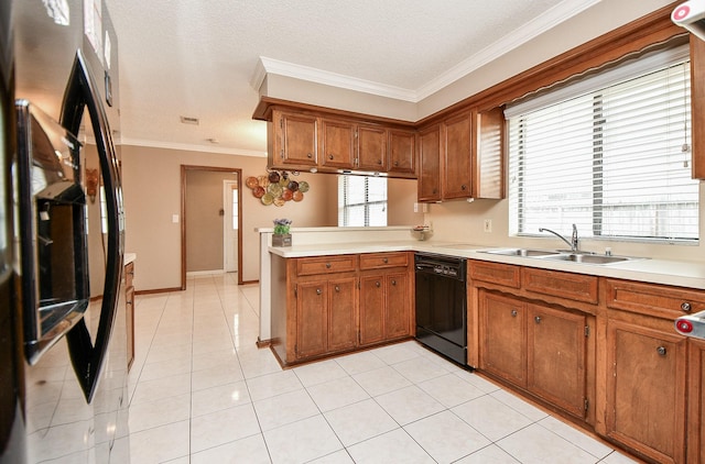 kitchen with sink, crown molding, kitchen peninsula, a healthy amount of sunlight, and black appliances