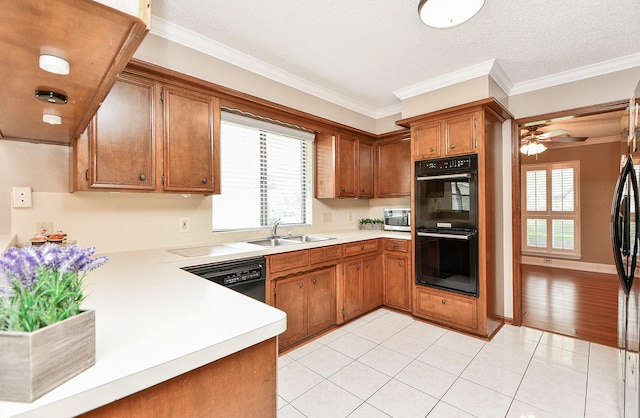 kitchen with sink, light tile patterned floors, ornamental molding, ceiling fan, and black appliances