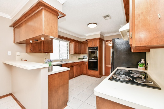 kitchen featuring sink, crown molding, light tile patterned floors, kitchen peninsula, and black appliances