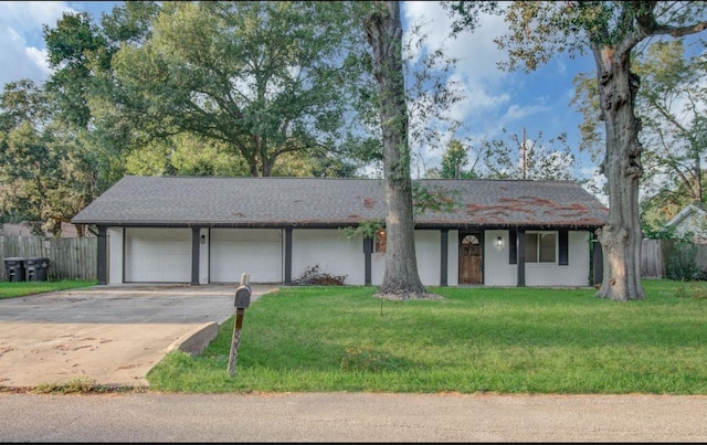 ranch-style house featuring a front yard and a garage