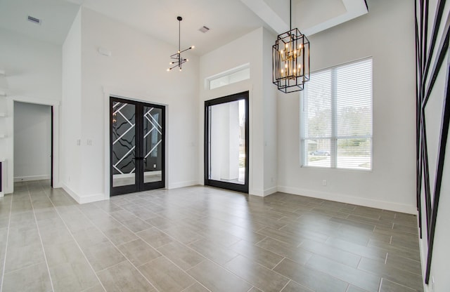 entrance foyer featuring a high ceiling and a notable chandelier