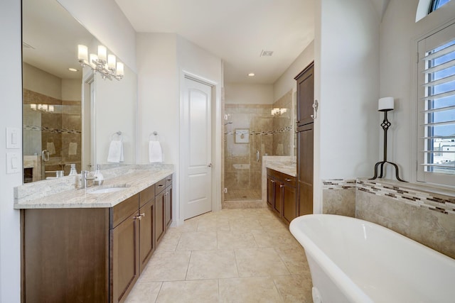 bathroom featuring vanity, an inviting chandelier, tile patterned floors, and independent shower and bath