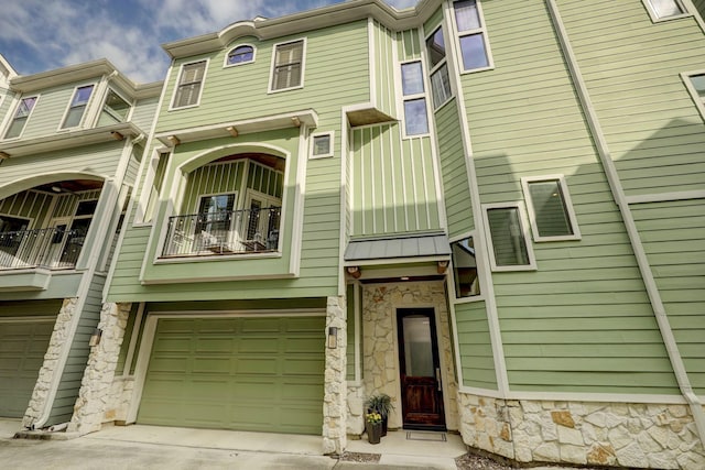 townhome / multi-family property featuring a balcony and a garage