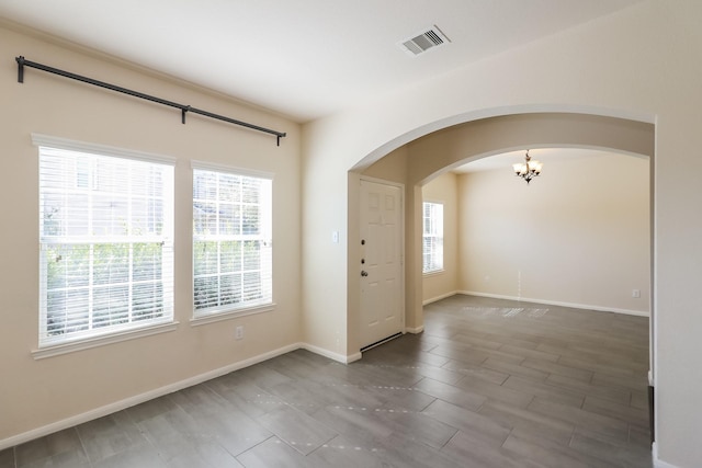 entrance foyer featuring an inviting chandelier