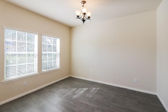 unfurnished room with an inviting chandelier