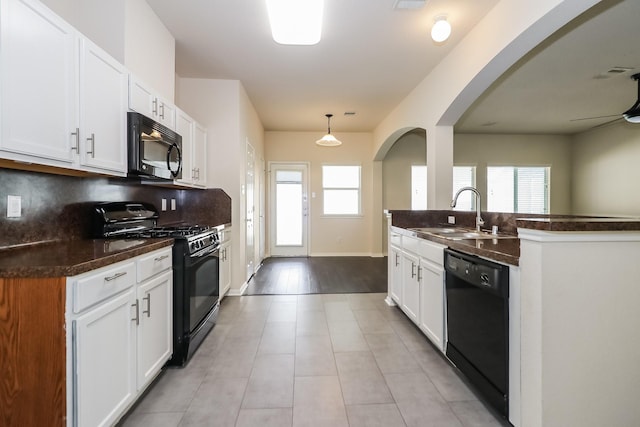 kitchen with white cabinets, sink, and black appliances