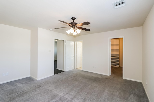 unfurnished room featuring dark colored carpet and ceiling fan