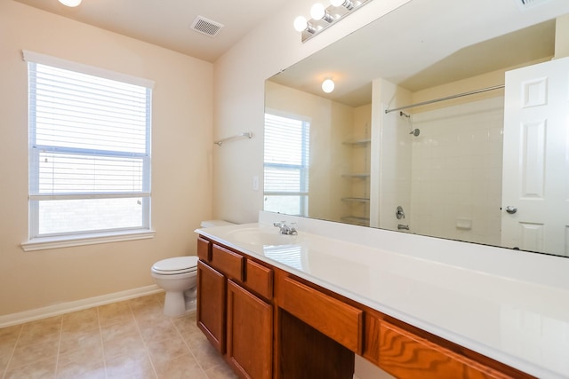 bathroom featuring tile patterned floors, vanity, and toilet