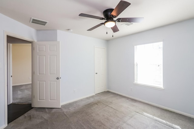 unfurnished bedroom featuring carpet, a closet, and ceiling fan