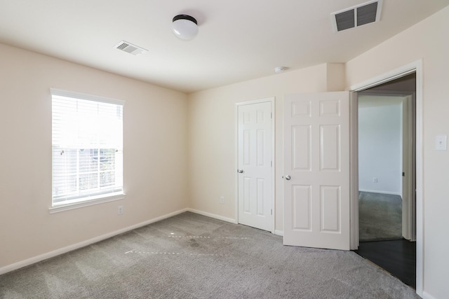 unfurnished bedroom with light carpet and a closet