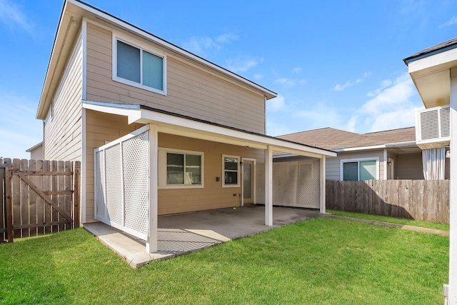 back of property featuring a yard and a patio