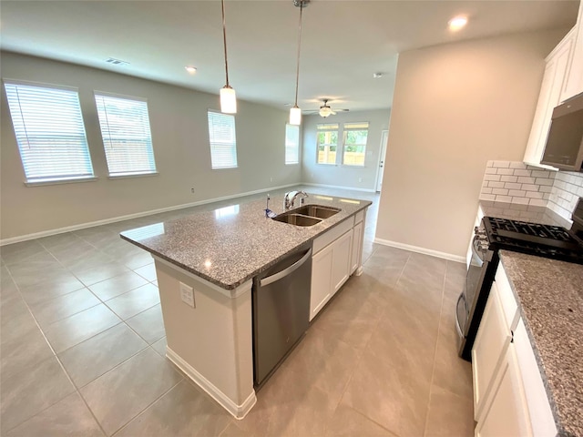 kitchen with sink, light stone countertops, an island with sink, white cabinetry, and stainless steel appliances