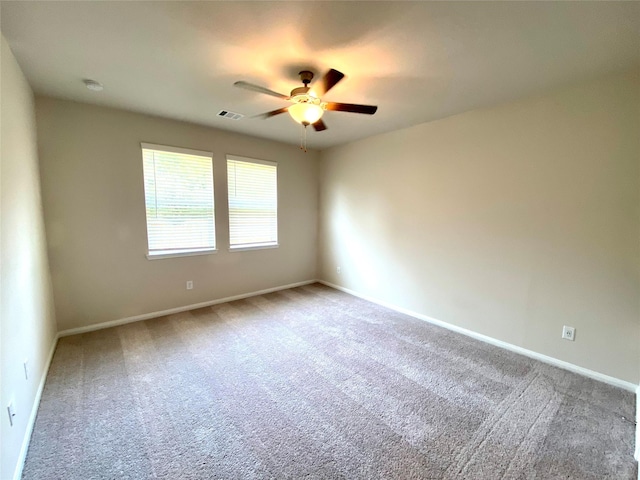 empty room with ceiling fan and carpet floors