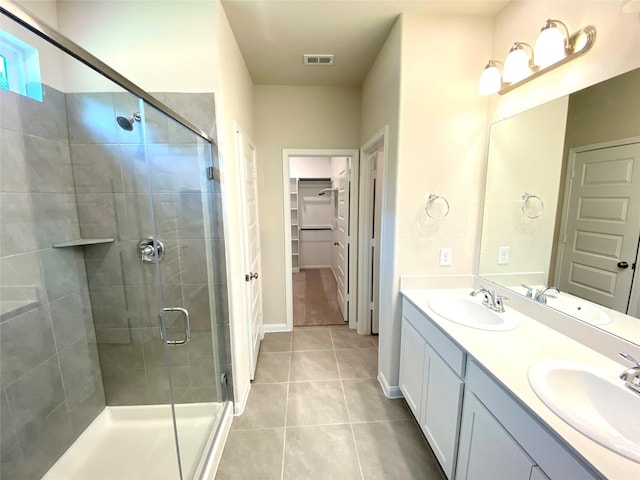 bathroom with tile patterned flooring, vanity, and an enclosed shower