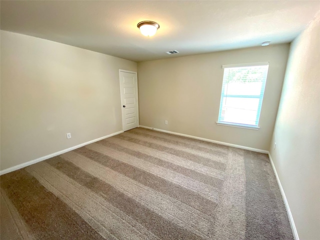 unfurnished room featuring carpet flooring