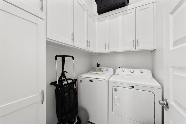 laundry area with cabinets and separate washer and dryer