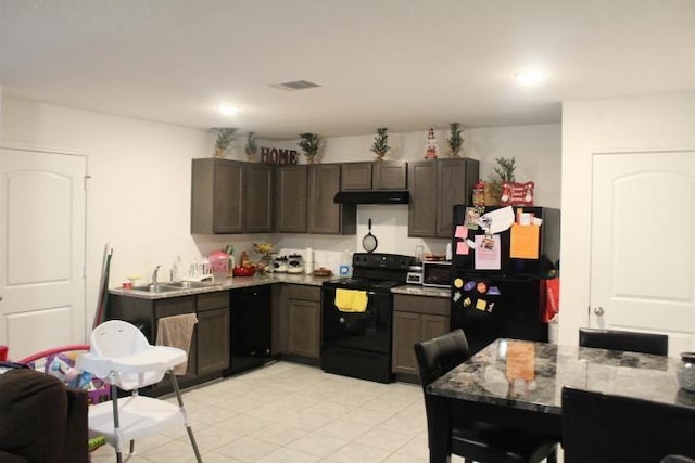 kitchen featuring sink, dark brown cabinetry, and black appliances